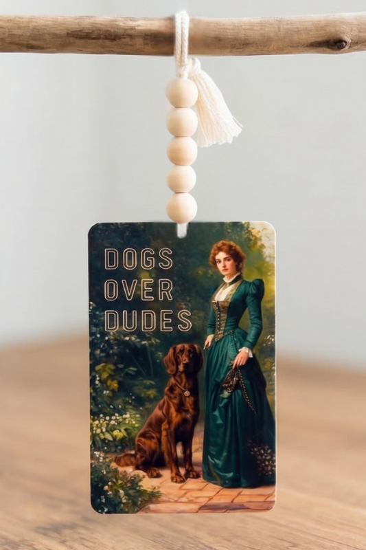 Car Air Freshener with 'Coffee Dogs Drama' text and peace sign on the surface