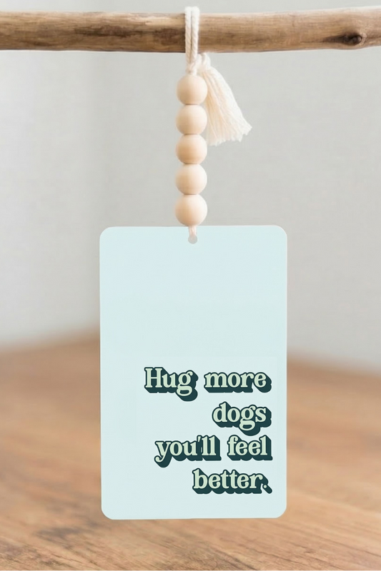 Car Air Freshener with 'Coffee Dogs Drama' text and peace sign on the surface