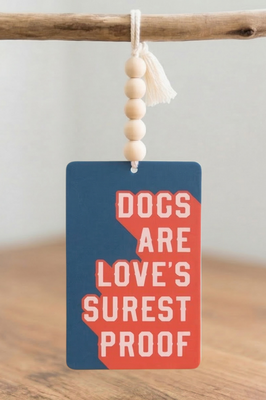 Car Air Freshener with 'Coffee Dogs Drama' text and peace sign on the surface